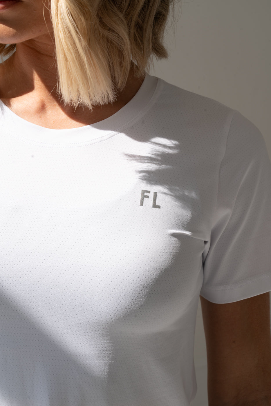 Woman Wearing White Padel t-shirt with fortyluv logo
